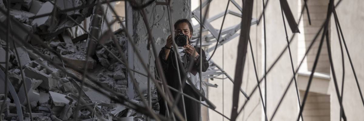 Photojournalist takes picture in rubble in Iran