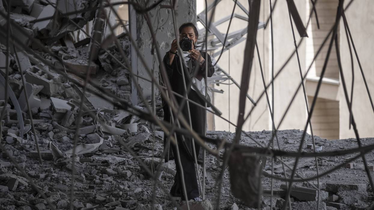Photojournalist takes picture in rubble in Iran