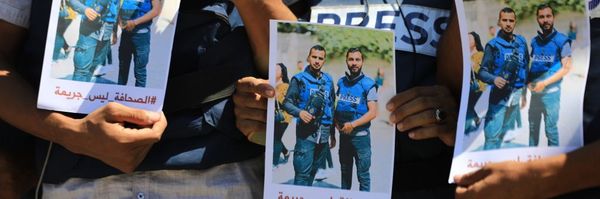 photos in honor of journalist Ismail al-Ghoul and cameraman Rami al-Rifee