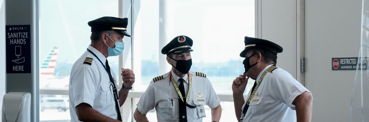 Pilots talk after exiting a Delta Airlines flight at the Ronald Reagan National Airport on July 22, 2020