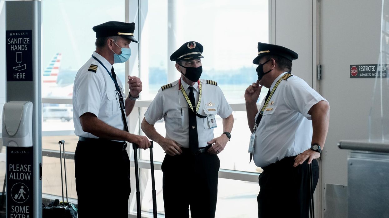 Pilots talk after exiting a Delta Airlines flight at the Ronald Reagan National Airport on July 22, 2020