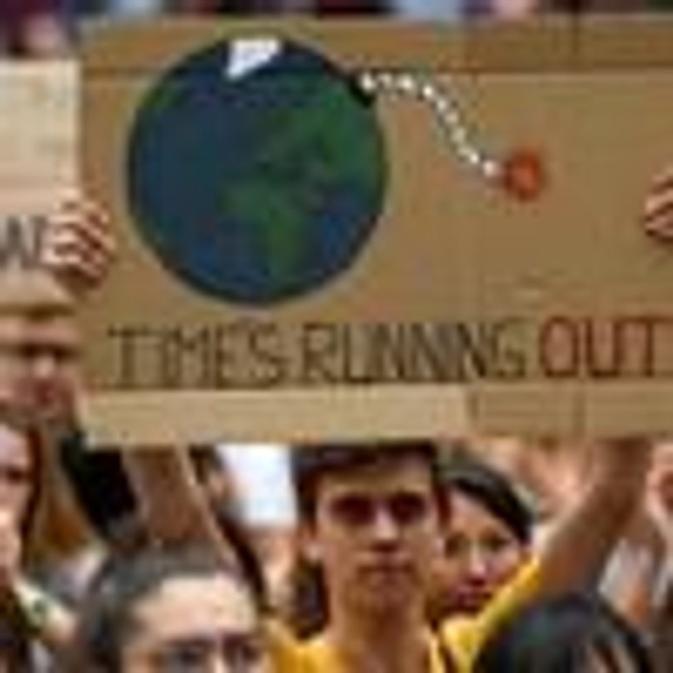 Placard reads: Time's running out