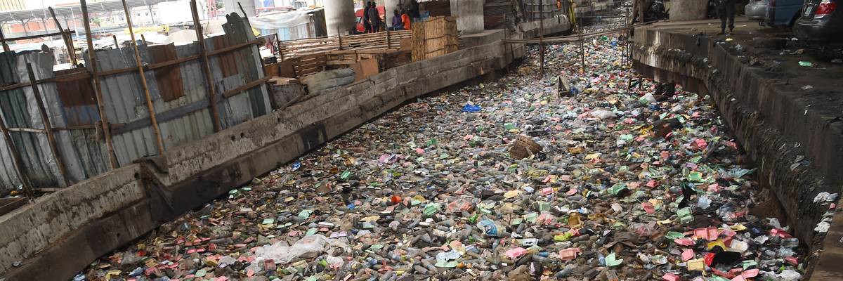 Plastic waste floats in a canal in Lagos.