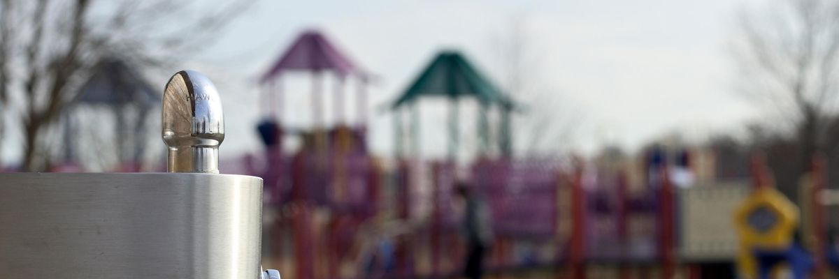 Playground with water fountain in foreground