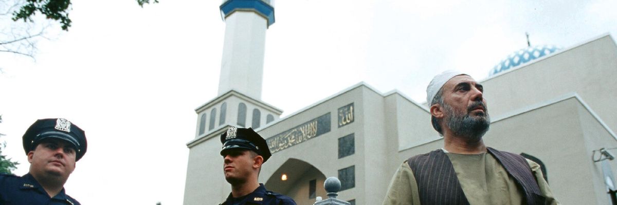 Police and a man outside Hazrati Abu Bakr Siddique mosque