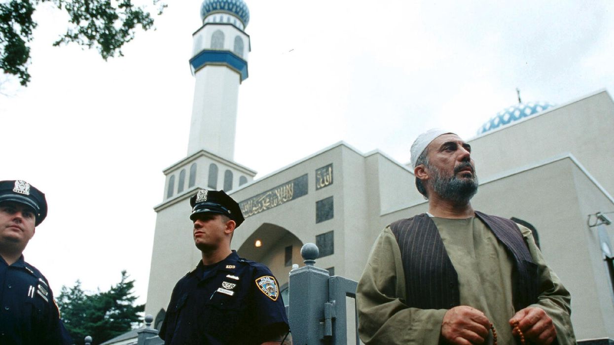 Police and a man outside Hazrati Abu Bakr Siddique mosque