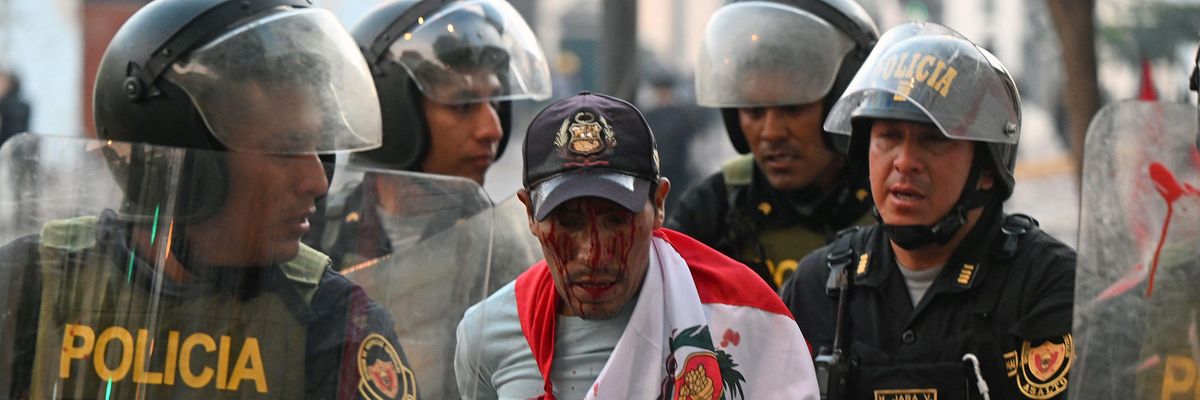 Police arrest a demonstrator during a protest in Lima