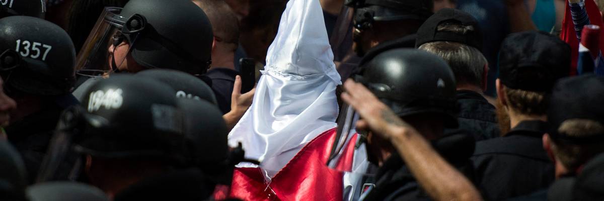 Police escort KKK members after a 2017 rally to protect Confederate monuments in Charlottesville, VA