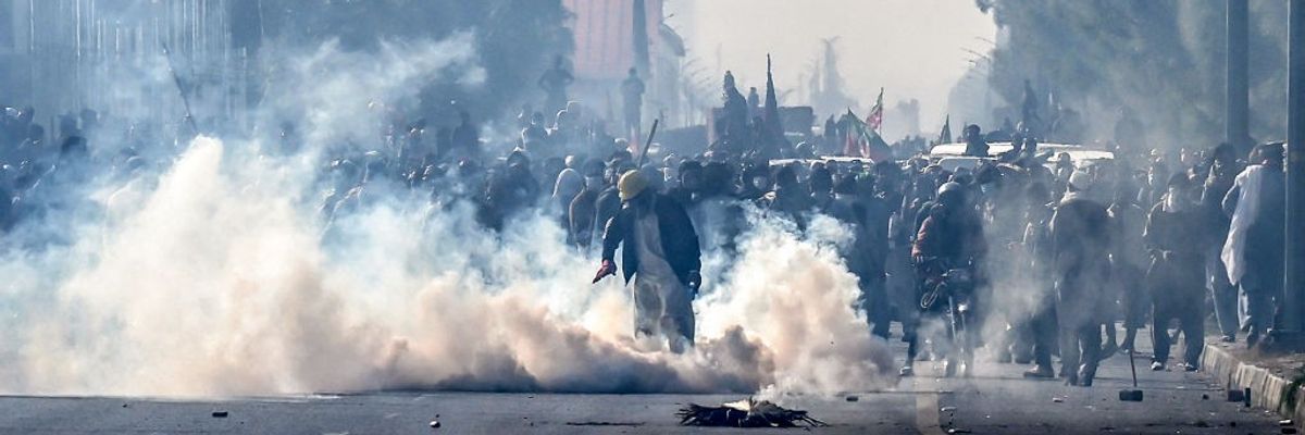 Police fire tear gas shells to disperse supporters of the Pakistan Tehreek-e-Insaf