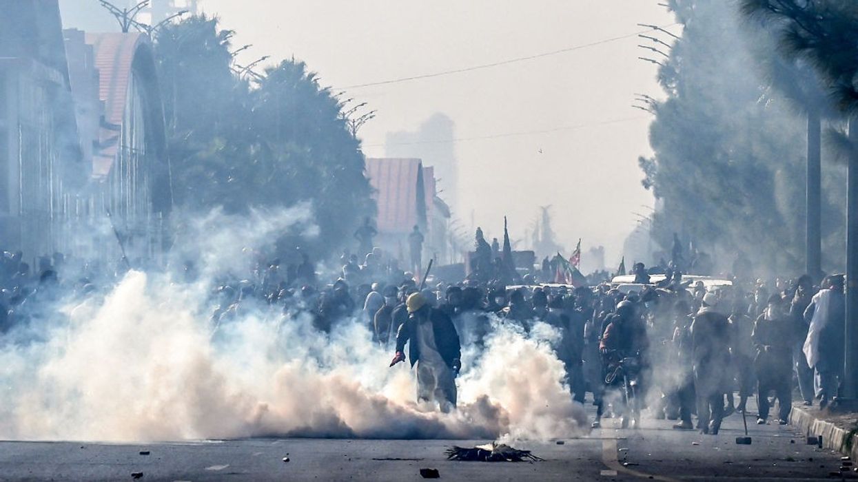 Police fire tear gas shells to disperse supporters of the Pakistan Tehreek-e-Insaf