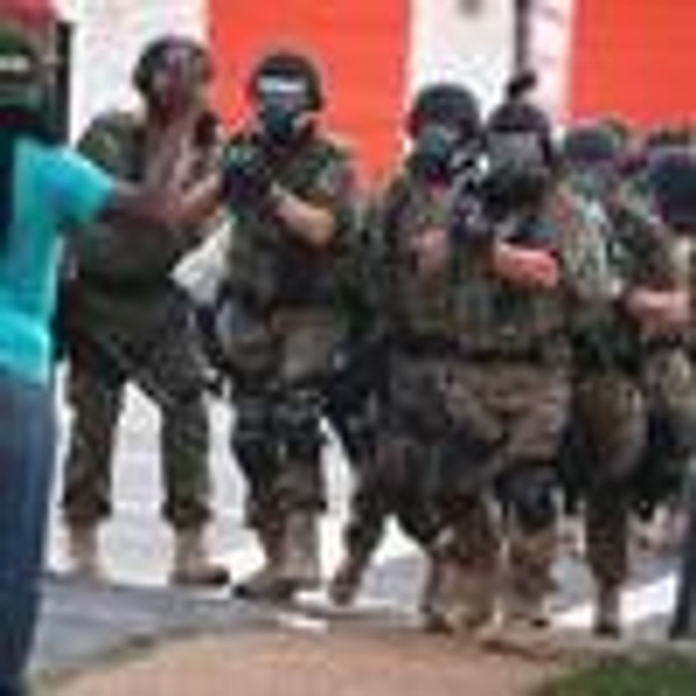 Police force protestors from the business district into nearby neighborhoods on August 11, 2014 in Ferguson, Missouri. Police responded with tear gas and rubber bullets as residents and their supporters protested the shooting by police of an unarmed black teenager named Michael Brown who was killed Saturday in this suburban St. Louis community.