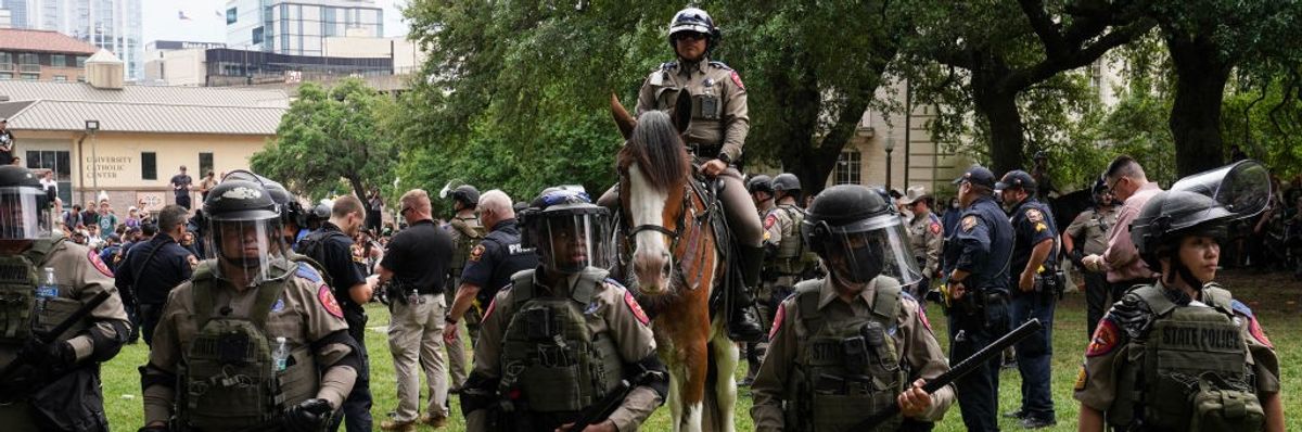 Police in riot gear prepare to arrest student protesters at the University of Texas, Austin 