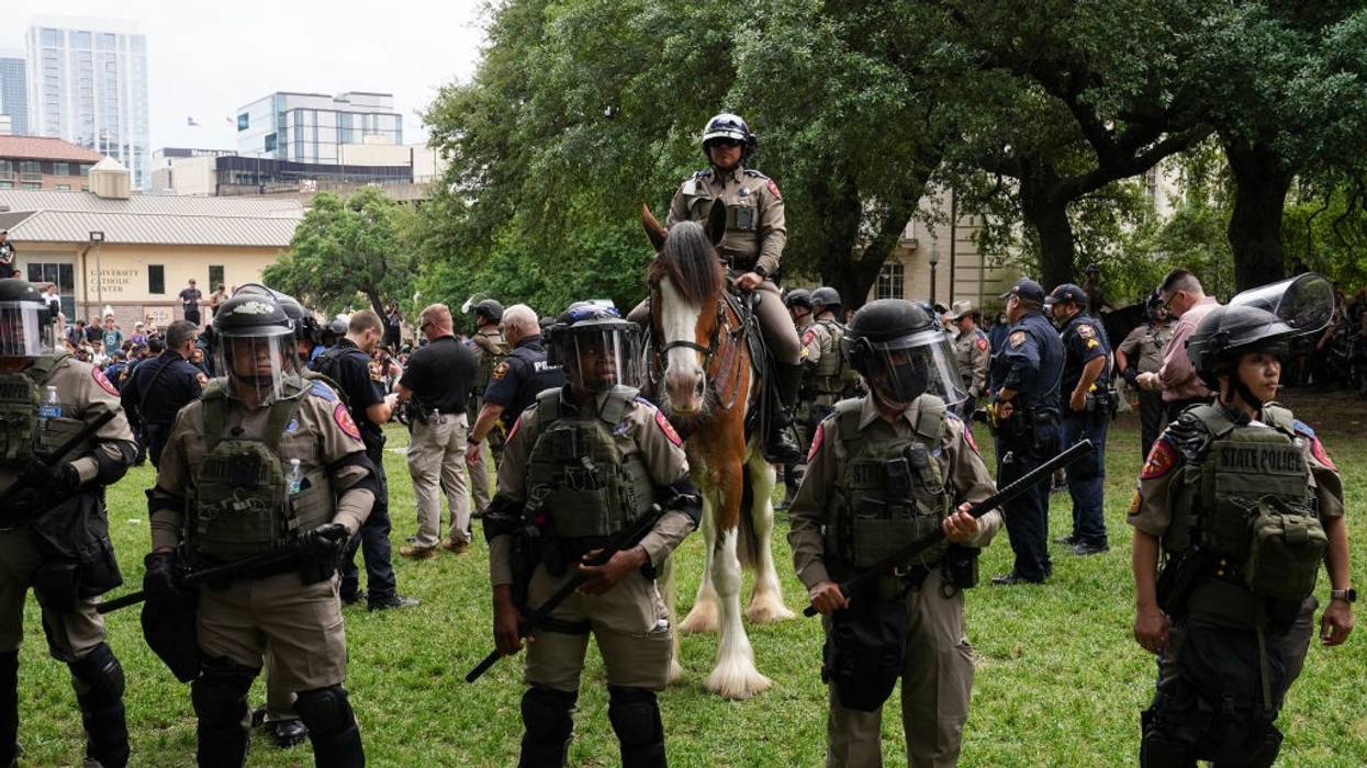 Police in riot gear prepare to arrest student protesters at the University of Texas, Austin