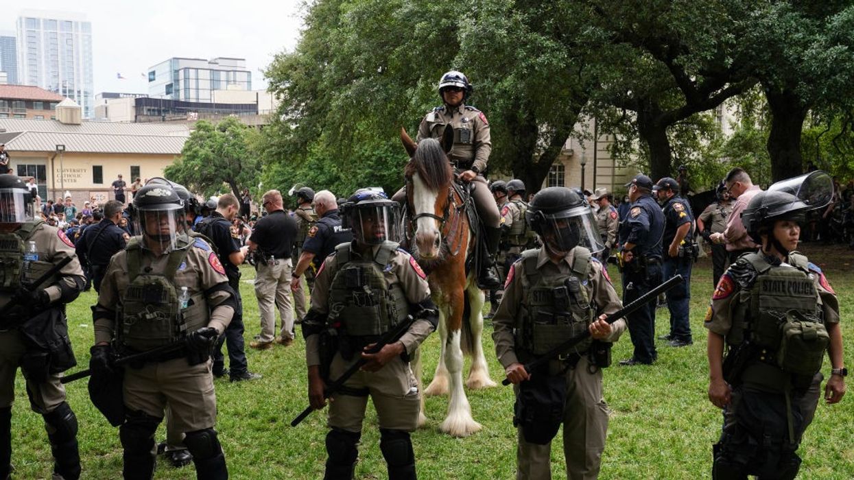 Police in riot gear prepare to arrest student protesters at the University of Texas, Austin
