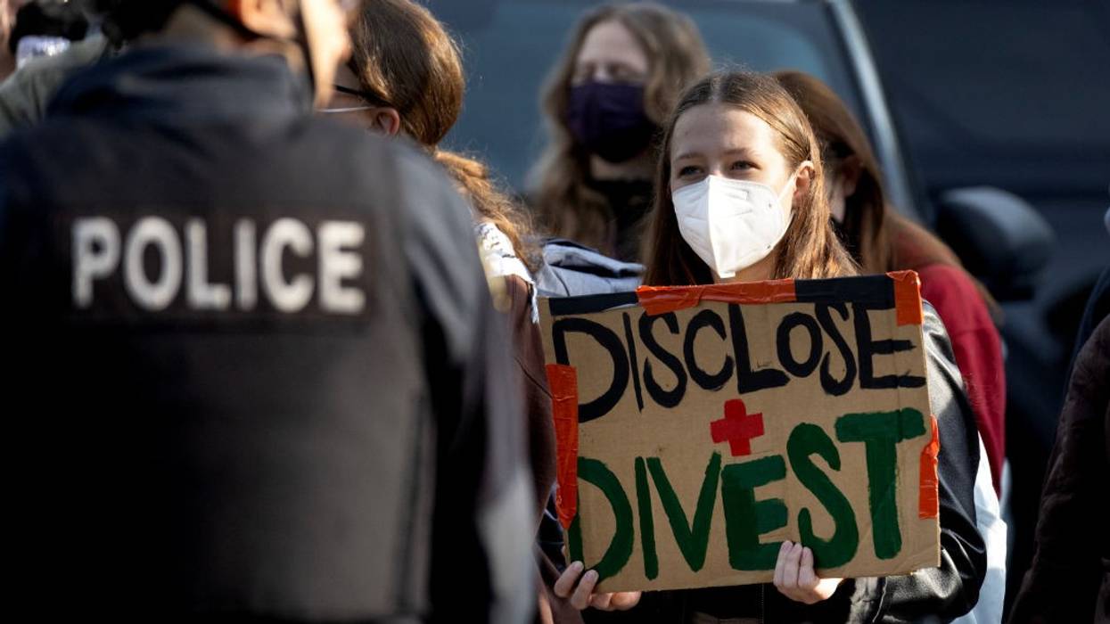 Police keep activists back as workers remove a pro-Palestinian encampment