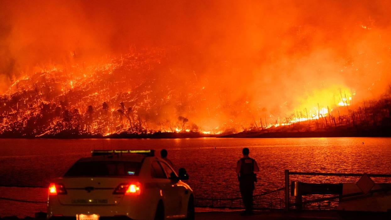 Police look on as forest fire burns in Oroville