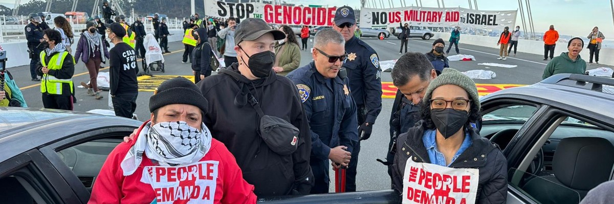 Police officers arrest Gaza cease-fire protesters on the Bay Bridge.