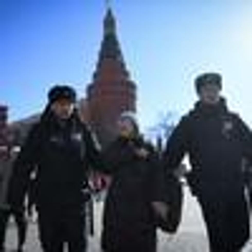 Police officers detain an elderly woman as she protests against Russia's invasion of Ukraine, in central Moscow on March 20, 2022.