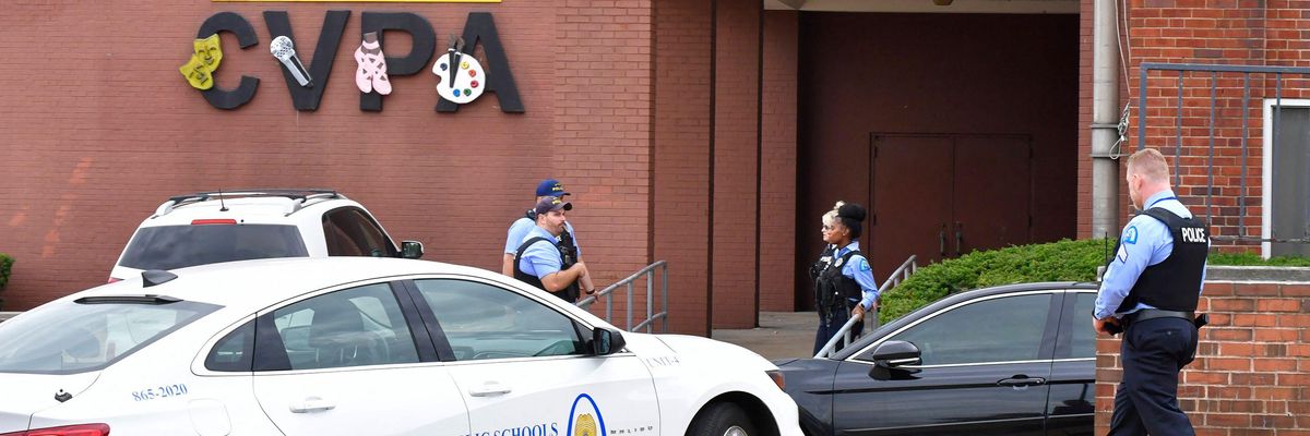 Police officers stand outside an entrance to the Central Visual and Performing Arts High School after a shooting that left three people dead in St. Louis, Missouri on October 24, 2022.