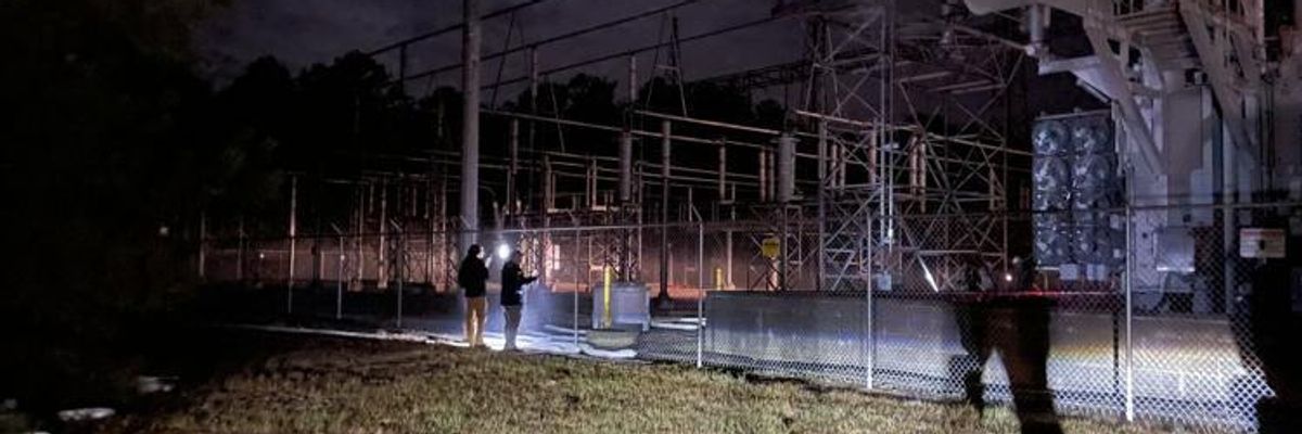 Police officers survey the perimeter line of the West End substation in Moore County, North Carolina on December 3, 2022.