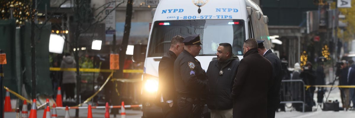 Police stand in the road.