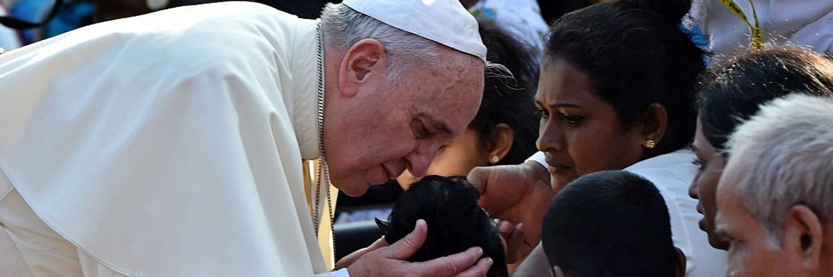 Pope Francis kisses a sick child