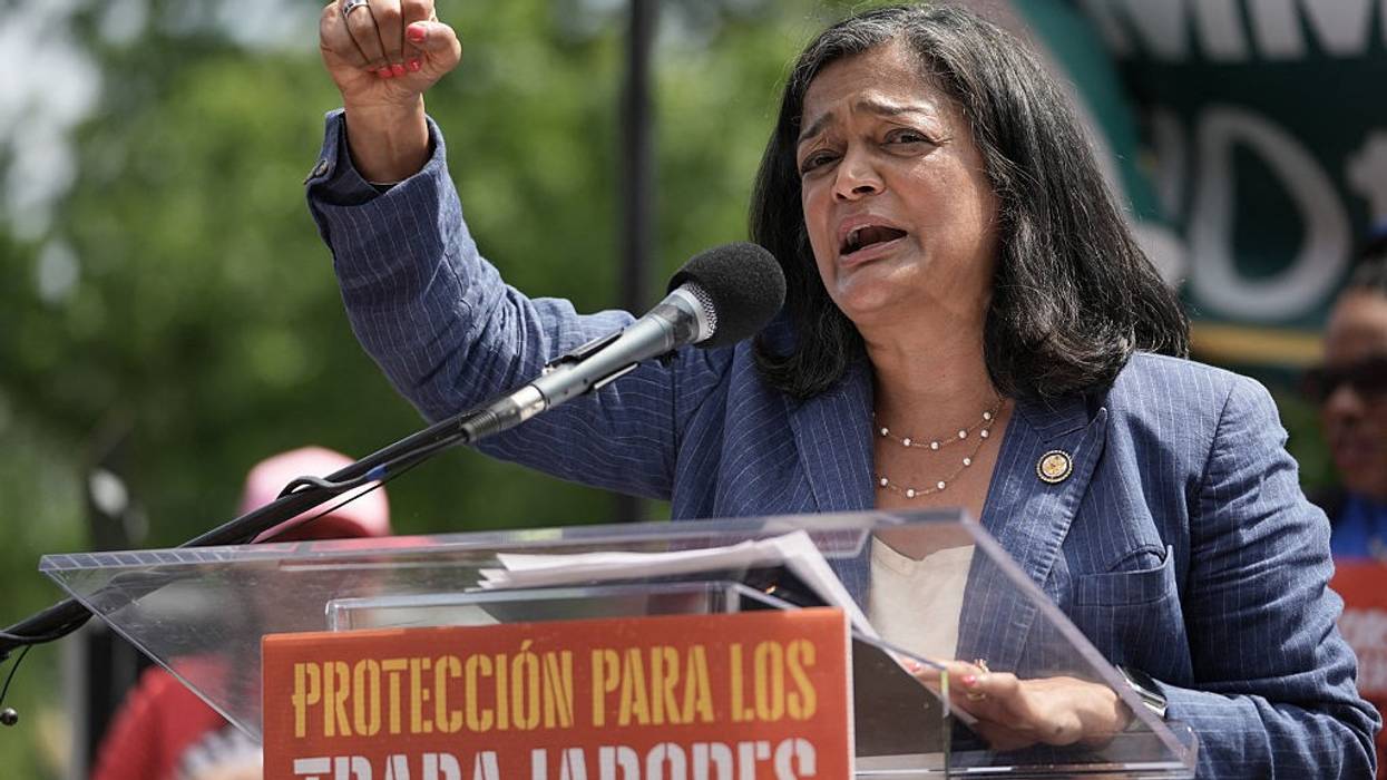 Pramila Jayapal speaks with a raised fist