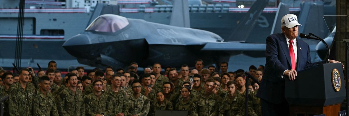 President Donald Trump delivers a speech in front of US Navy personnel