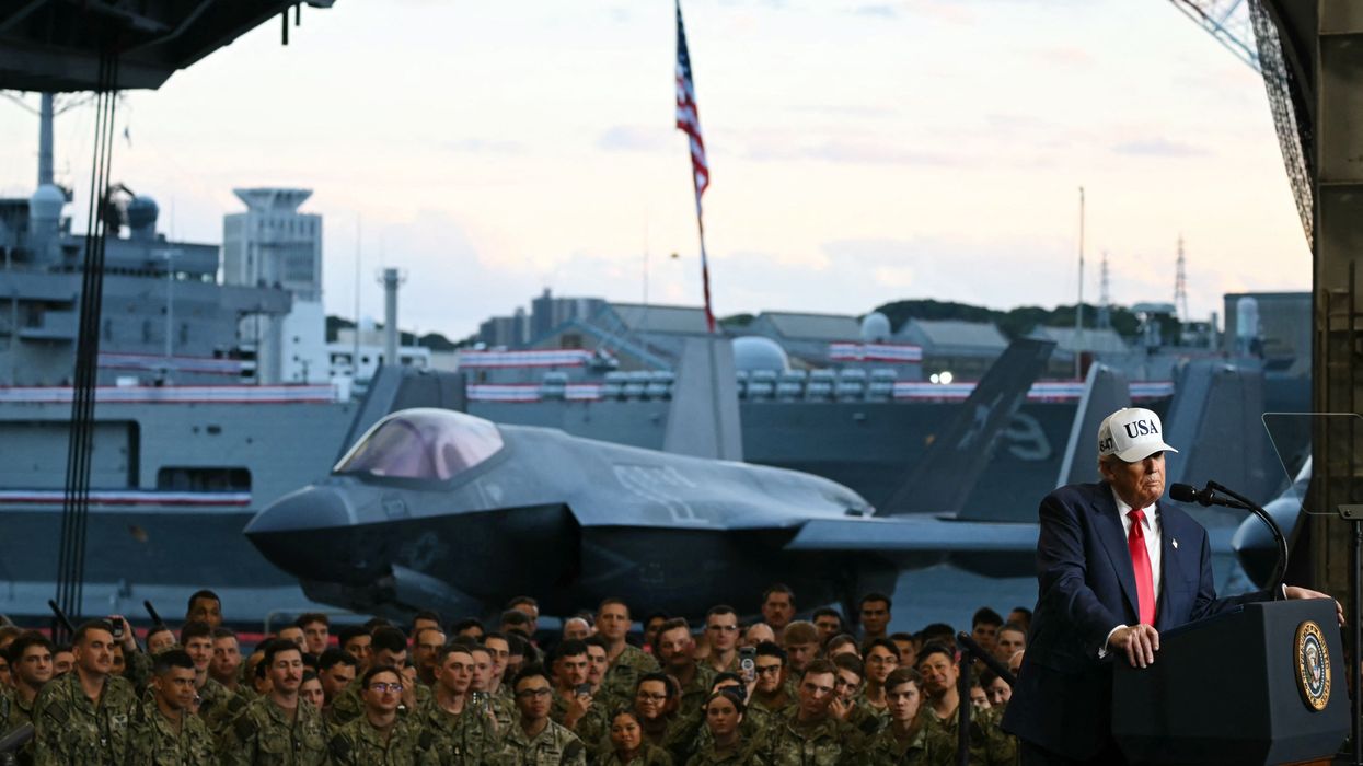 President Donald Trump delivers a speech in front of US Navy personnel