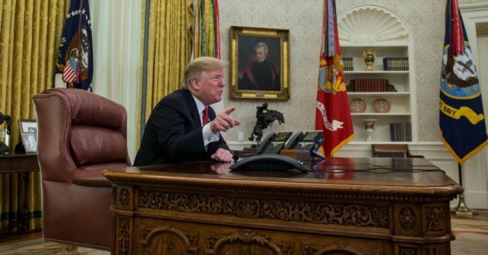 President Donald Trump makes a video call to service members from the Army, Marine Corps, Navy, Air Force, and Coast Guard stationed worldwide in the Oval Office at the White House December 25, 2018 in Washington, DC. (Photo: Zach Gibson-Pool/Getty Images)