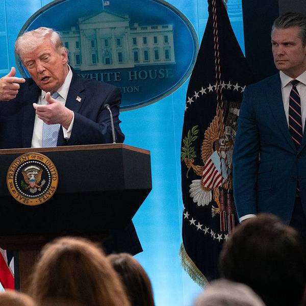 President Donald Trump mimics firing a rifle