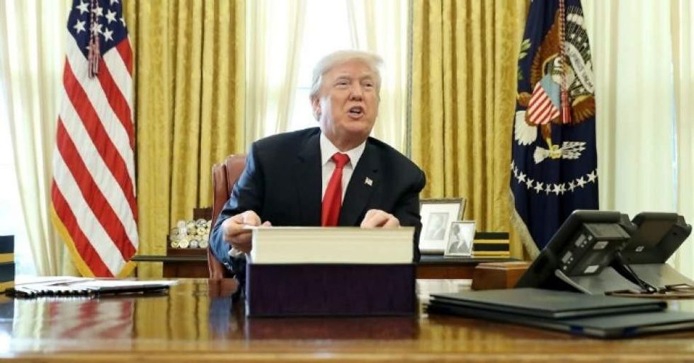 President Donald Trump talks with journalists after signing tax reform legislation into law in the Oval Office December 22, 2017 in Washington, D.C. (Photo: Chip Somodevilla/Getty Images)