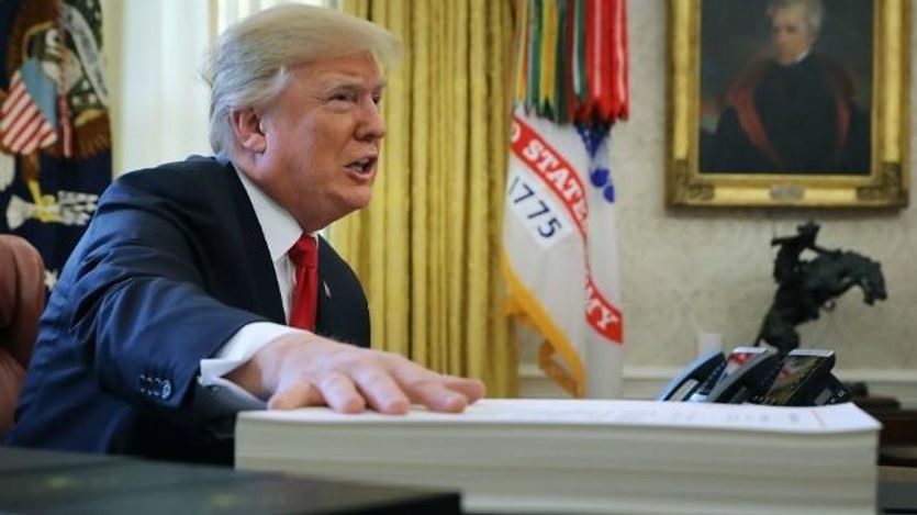 President Donald Trump talks with journalists before signing tax reform legislation into law in the Oval Office December 22, 2017 in Washington, DC. Trump praised Republican leaders in Congress for all their work on the biggest tax overhaul in decades. (Photo: Chip Somodevilla/Getty Images)