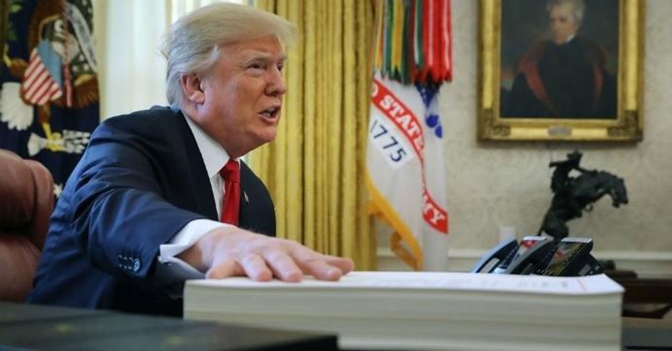 President Donald Trump talks with journalists before signing tax reform legislation into law in the Oval Office December 22, 2017 in Washington, DC. Trump praised Republican leaders in Congress for all their work on the biggest tax overhaul in decades. (Photo: Chip Somodevilla/Getty Images)