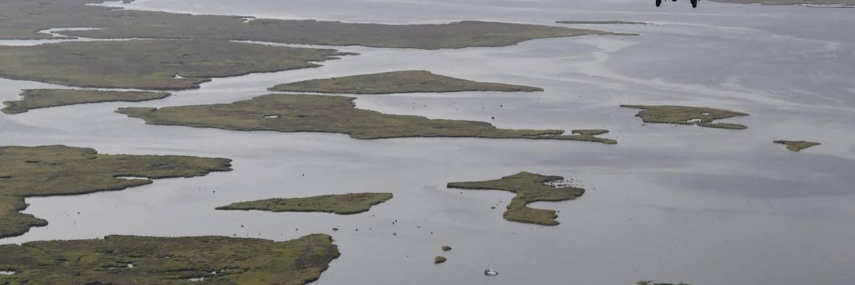 President Joe Biden, aboard the Marine One helicopter, inspects the damage from Hurricane Ida