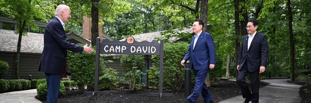President Joe Biden extends his hand to Japanese Prime Minister Fumio Kishida and South Korean President Yoon Suk Yeol.