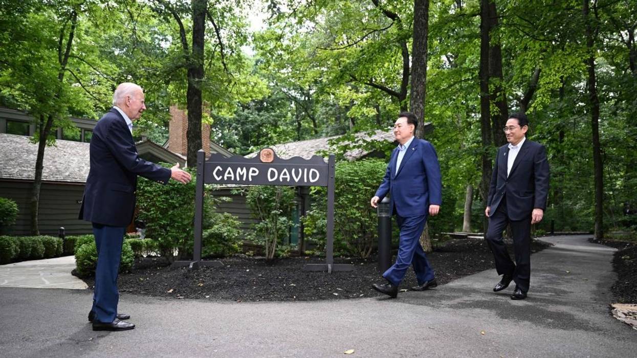 President Joe Biden extends his hand to Japanese Prime Minister Fumio Kishida and South Korean President Yoon Suk Yeol.