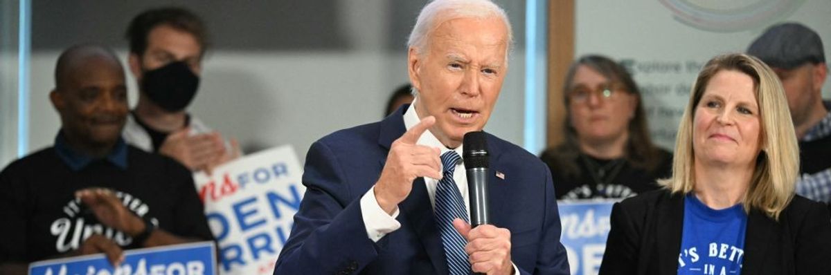 President Joe Biden speaks as AFL-CIO president Liz Shuler stands by