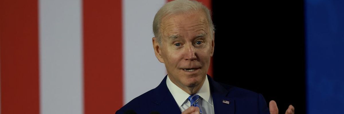 President Joe Biden speaks at a podium.