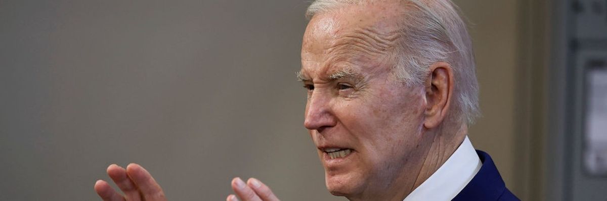 President Joe Biden speaks with his hands raised.