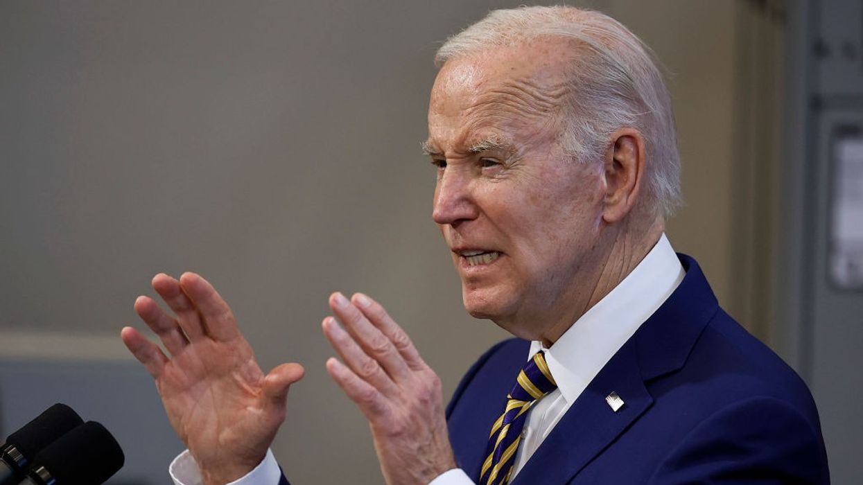 President Joe Biden speaks with his hands raised.