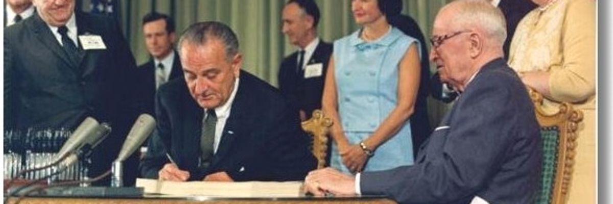 President Johnson signs Medicare into law.