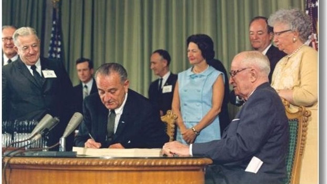 President Johnson signs Medicare into law.