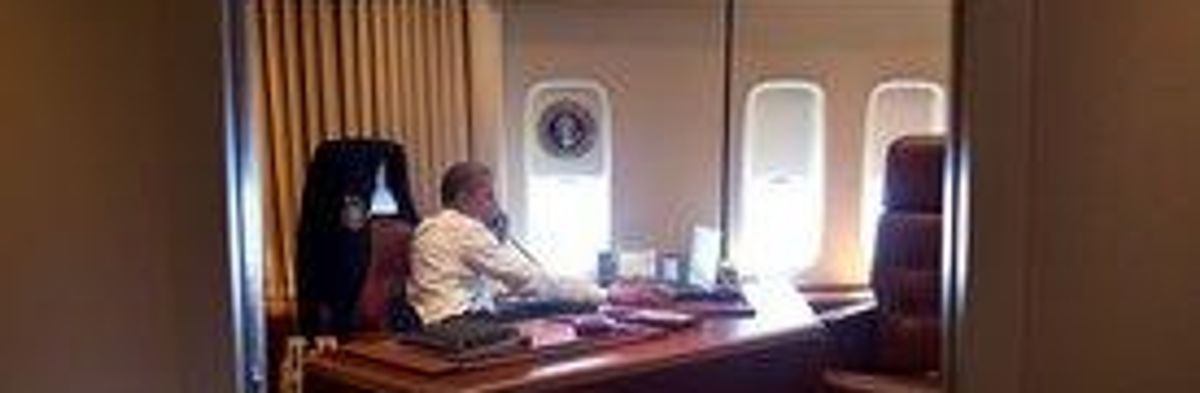 President Obama takes a phone call aboard Air Force One, July 2012
