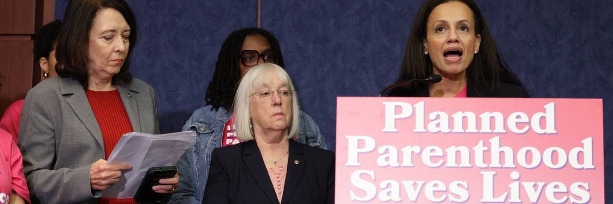 President of Planned Parenthood Alexis McGill Johnson speaks at a podium that says "Planned Parenthood Saves Lives."