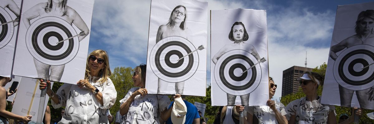 Pro-choice demonstrators with posters showing bullseyes on women's bodies