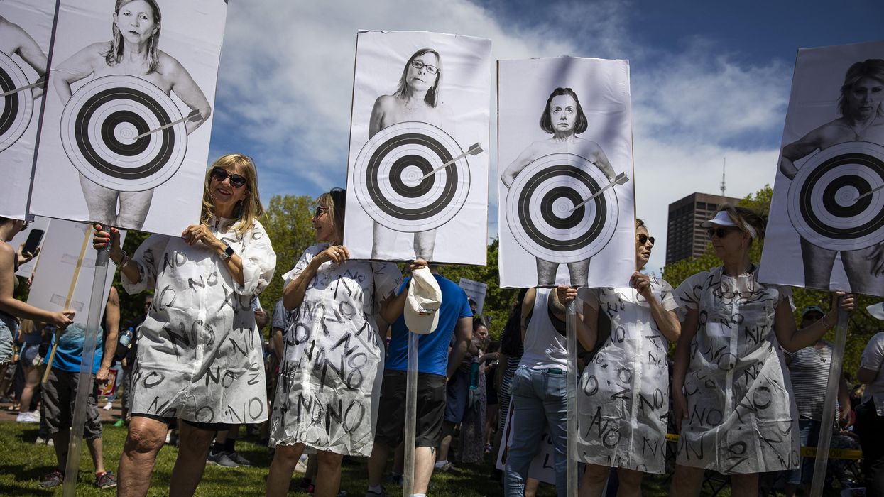 Pro-choice demonstrators with posters showing bullseyes on women's bodies