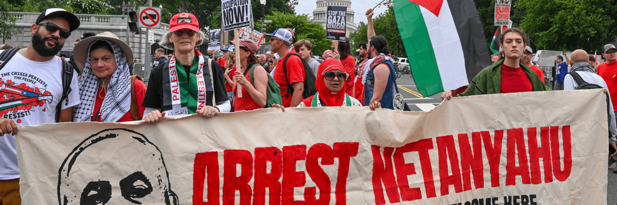 Pro-Palestine protesters hold a banner reading, "Arrest Netanyahu: War Criminals Are Not Welcome Here"