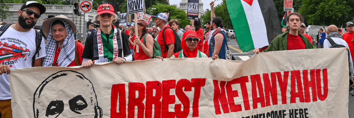 Pro-Palestine protesters hold a banner reading, "Arrest Netanyahu: War Criminals Are Not Welcome Here"
