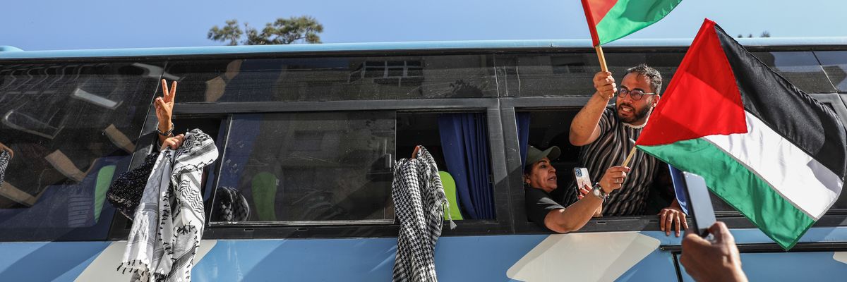 Pro-Palestinian activists wave Palestinian flags and keffiyehs from open bus windows